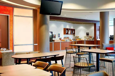 a restaurant with tables and chairs and a flat screen tv at SpringHill Suites by Marriott Columbus OSU in Columbus