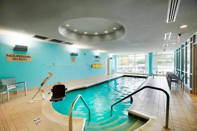 a swimming pool with a swimmer in the middle at SpringHill Suites by Marriott Columbus OSU in Columbus