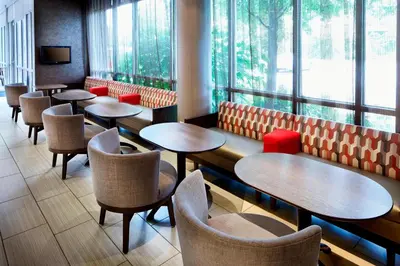 a restaurant with tables and chairs and windows at SpringHill Suites by Marriott Columbus OSU in Columbus