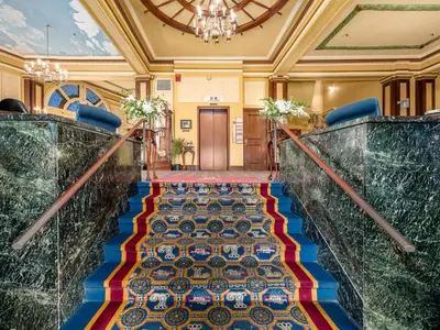 a staircase in a building with a colorful carpet at Lafayette Hotel Marietta in Marietta