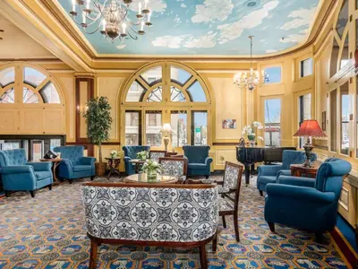 a lobby with blue chairs and a table at Lafayette Hotel Marietta in Marietta