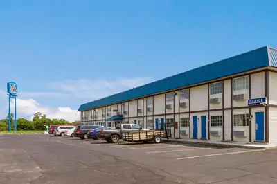 a large building with cars parked in a parking lot at Motel 6-Rossford, OH in Rossford