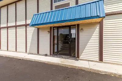 a building with a window with a blue awning at Motel 6-Rossford, OH in Rossford