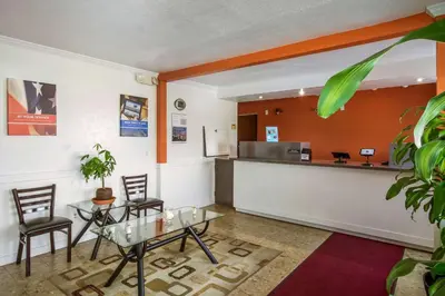 a waiting room with a table and chairs and a counter at Motel 6-Rossford, OH in Rossford