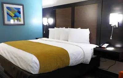 a large bed in a hotel room with a phone at SureStay Hotel by Best Western Florence in Florence