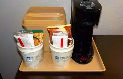 a tray with a coffee maker and some food at SureStay Hotel by Best Western Florence in Florence