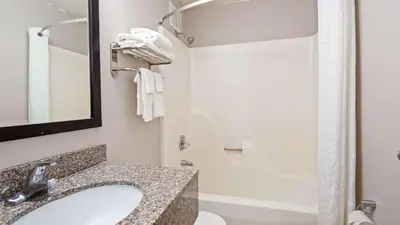 a bathroom with a sink and a toilet and a shower at SureStay Hotel by Best Western Florence in Florence