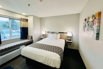 a hotel room with a bed and a window at Microtel Inn Georgetown - Lexington North in Georgetown