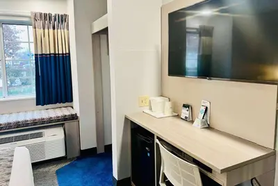 a hotel room with a desk and a window at Microtel Inn Georgetown - Lexington North in Georgetown