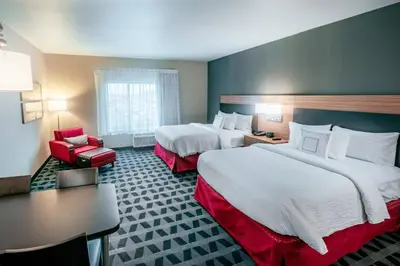 a hotel room with two beds and a chair at TownePlace Suites by Marriott Toledo Oregon in Oregon