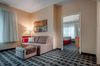 a living room with a couch and a chair at TownePlace Suites by Marriott Toledo Oregon in Oregon