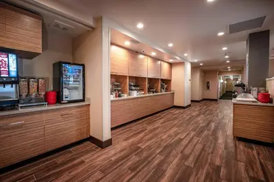 a large room with wooden floors and a restaurant at TownePlace Suites by Marriott Toledo Oregon in Oregon