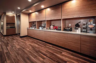 a kitchen with wooden cabinets and a counter top at TownePlace Suites by Marriott Toledo Oregon in Oregon