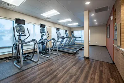 a fitness room with treadmills and elliptical machines at TownePlace Suites by Marriott Toledo Oregon in Oregon