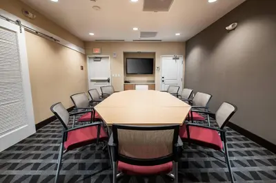 a conference room with a table and chairs at TownePlace Suites by Marriott Toledo Oregon in Oregon