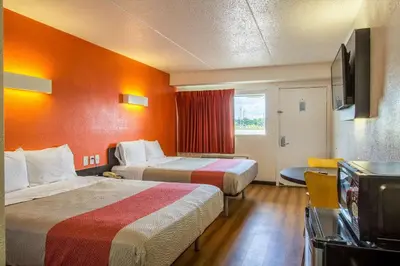 a hotel room with two beds and a television at Motel 6-Ashland, OH in Ashland