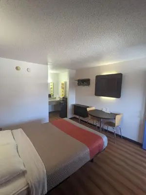 a hotel room with a bed and a table and a tv at Motel 6-Ashland, OH in Ashland