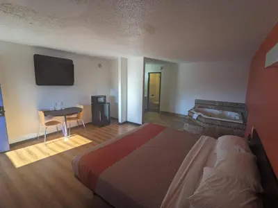 a hotel room with a bed and a table and a television at Motel 6-Ashland, OH in Ashland