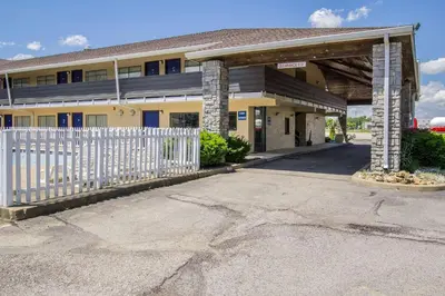 a building with a white fence in front of it at Motel 6-Ashland, OH in Ashland