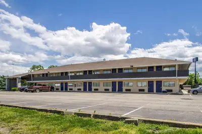 a building with a parking lot in front of it at Motel 6-Ashland, OH in Ashland