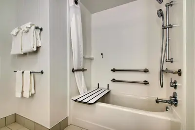 a white bathroom with a tub and a shower at Holiday Inn Express & Suites Findlay North by IHG in Findlay