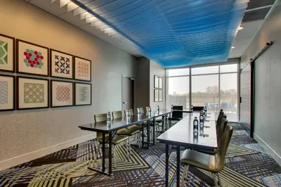 a conference room with tables and chairs and a blue ceiling at Holiday Inn Express & Suites Findlay North by IHG in Findlay