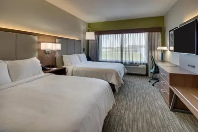 a hotel room with two beds and a flat screen tv at Holiday Inn Express & Suites Findlay North by IHG in Findlay