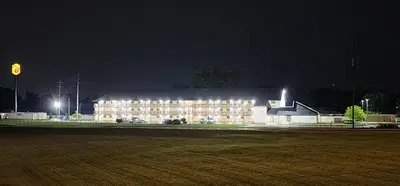 a large building is lit up at night at Super 8 by Wyndham Vandalia/Dayton International Airport in Vandalia