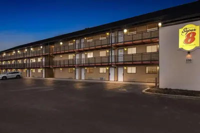 a large parking lot in front of a hotel at Super 8 by Wyndham Vandalia/Dayton International Airport in Vandalia