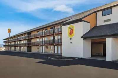 a hotel building with a mcdonalds sign in a parking lot at Super 8 by Wyndham Vandalia/Dayton International Airport in Vandalia