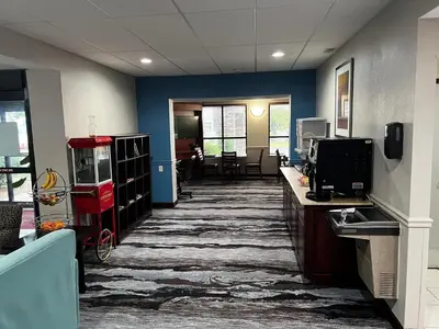 an office with a hallway with blue walls and a desk at Baymont By Wyndham Monroe Ohio in Monroe