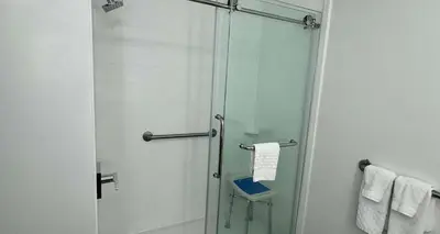 a shower with a glass door in a bathroom at Best Western PLUS Hannaford Inn & Suites in Cincinnati