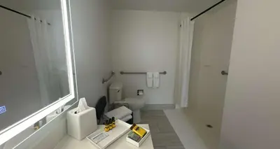 a white bathroom with a toilet and a sink at Best Western PLUS Hannaford Inn & Suites in Cincinnati