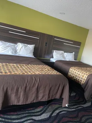 two beds sitting next to each other in a room at Blue Stone Inn in Washington Court House