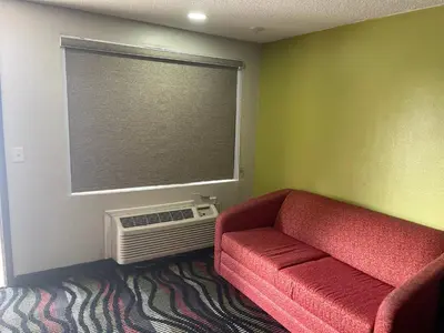 a living room with a red couch and a window at Blue Stone Inn in Washington Court House