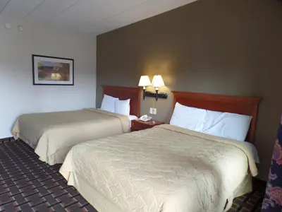 a hotel room with two beds and two lamps at Executive Inn Chillicothe in Chillicothe