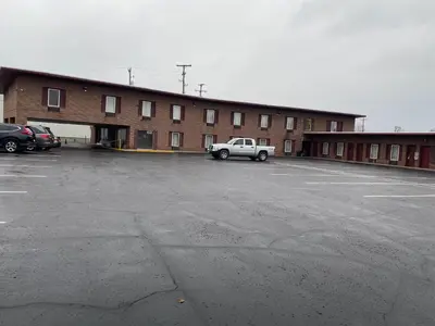 a white truck parked in a parking lot in front of a building at Executive Inn Chillicothe in Chillicothe