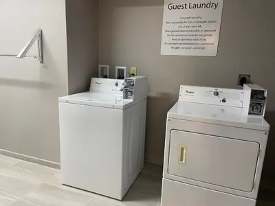 a laundry room with a washer and a dishwasher at Holiday Inn Express & Suites Elyria by IHG in Elyria