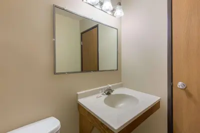 a bathroom with a sink and a mirror at Super 8 by Wyndham Youngstown/Austintown in Youngstown