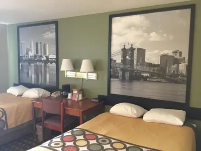a hotel room with two beds and a desk at Super 8 by Wyndham Youngstown/Austintown in Youngstown