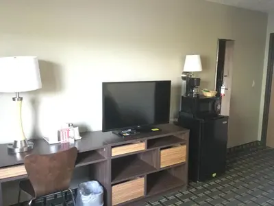 a room with a desk with a flat screen tv at Super 8 by Wyndham Youngstown/Austintown in Youngstown