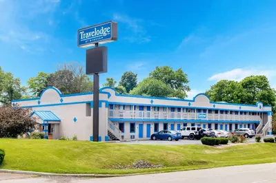 a building with a street sign in front of it at Travelodge by Wyndham Richmond IN in Richmond