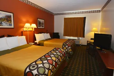 a hotel room with two beds and a flat screen tv at Super 8 by Wyndham Athens in Athens