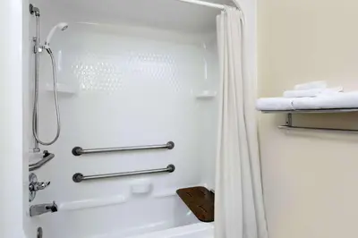 a bathroom with a shower with a shower curtain at Super 8 by Wyndham Athens in Athens