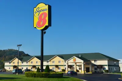 a sign for a super motel in a parking lot at Super 8 by Wyndham Athens in Athens