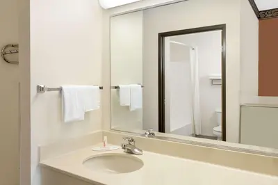 a bathroom with a sink and a mirror at Super 8 by Wyndham Athens in Athens