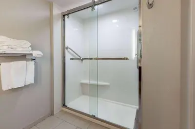 a shower with a glass door in a bathroom at Microtel Inn & Suites by Wyndham Sunbury - Columbus North in Sunbury