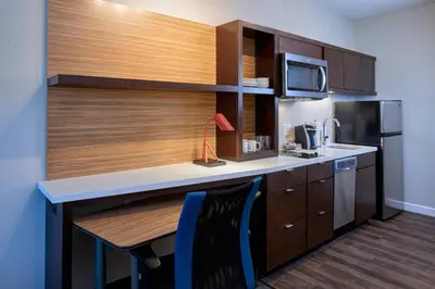 a small kitchen with a desk and a microwave at TownePlace Suites by Marriott Cleveland Solon in Solon