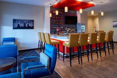 a bar with yellow and blue chairs in a restaurant at TownePlace Suites by Marriott Cleveland Solon in Solon