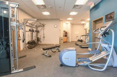 a gym with treadmills and machines in a room at Hilton Garden Inn Cincinnati Midtown in Cincinnati